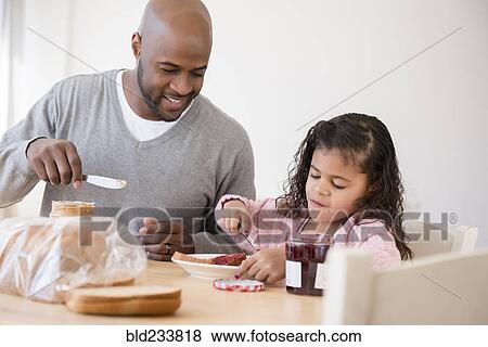 Father and daughter making sandwiches View Large Photo Image Stock Photo - Father and daughter making sandwiches. Fotosearch