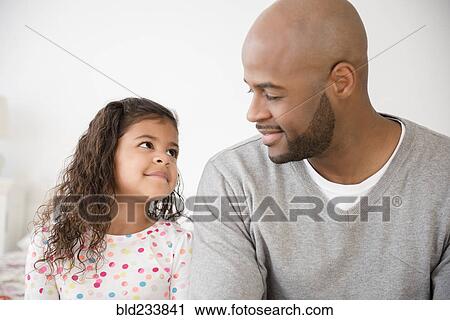 Stock Image - Father and daughter smiling. Fotosearch