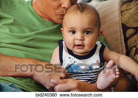Father kissing head of smiling baby son View Large Photo Image Stock Image - Father kissing head of smiling baby son. Fotosearch
