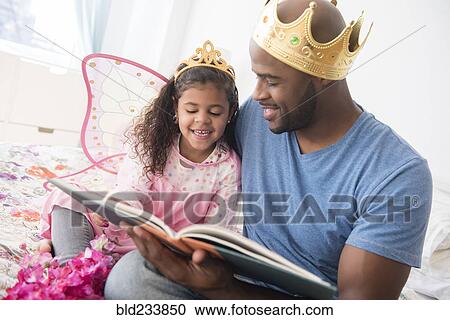 Father ready story to daughter on bed View Large Photo Image Stock Image - Father ready story to daughter on bed. Fotosearch