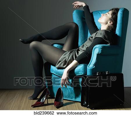 Fatigued Caucasian businesswoman unwinding in blue armchair View Large Photo Image Stock Image - Fatigued Caucasian businesswoman unwinding in blue armchair. Fotosearch
