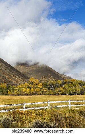 Fence and mountain under clouds View Large Photo Image Stock Image - Fence and mountain under clouds. Fotosearch