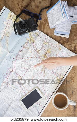 Finger of Caucasian woman pointing at map View Large Photo Image Stock Photo - Finger of Caucasian woman pointing at map. Fotosearch