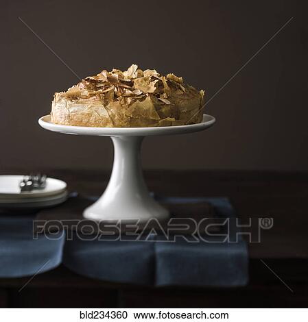Stock Image - Flaky cake on tray. Fotosearch