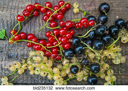 Stock Image - Fresh berries on wooden table. Fotosearch