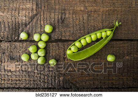 Fresh peas on wooden table View Large Photo Image Stock Photo - Fresh peas on wooden table. Fotosearch