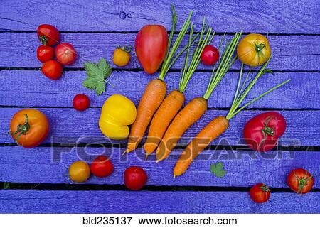 Fresh vegetables on purple wooden table View Large Photo Image Stock Photo - Fresh vegetables on purple wooden table. Fotosearch