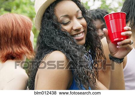 Stock Photo - Friends dancing and drinking together. Fotosearch
