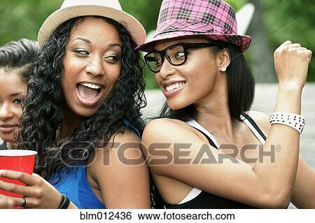 Friends dancing and drinking together View Large Photo Image Stock Photograph - Friends dancing and drinking together. Fotosearch