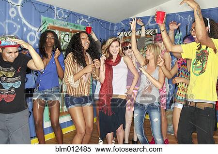 Friends dancing and drinking together at party View Large Photo Image Stock Photography - Friends dancing and drinking together at party. Fotosearch