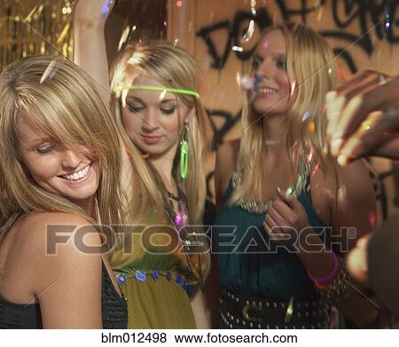Stock Photo - Friends dancing at party. Fotosearch