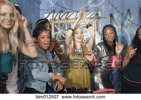 Stock Photo - Friends dancing at party. Fotosearch