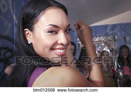 Stock Photo - Friends dancing at party. Fotosearch