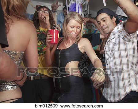 Stock Photo - Friends dancing at party. Fotosearch