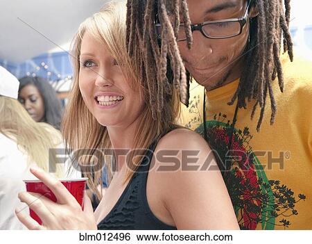 Stock Photograph - Friends dancing at party. Fotosearch