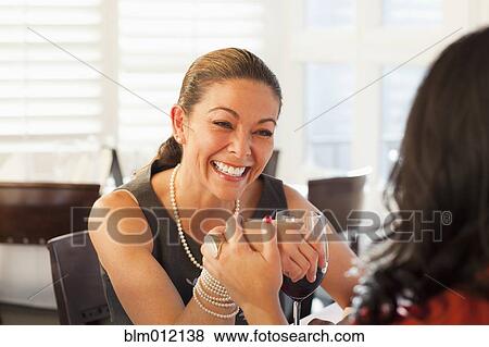 Friends drinking red wine in restaurant View Large Photo Image Stock Photo - Friends drinking red wine in restaurant. Fotosearch