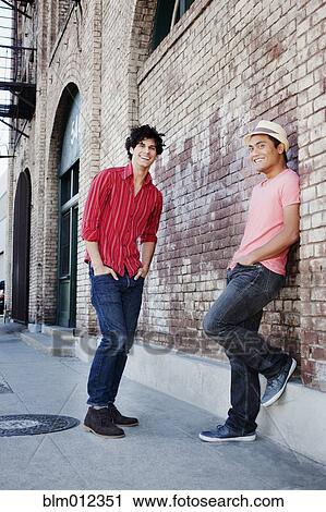 Stock Image - Friends hanging out in urban area. Fotosearch