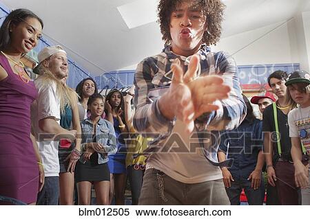 Stock Photography - Friends hanging out together at party. Fotosearch