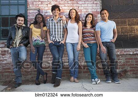 Picture - Friends hanging out together in urban area. Fotosearch