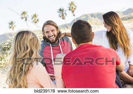 Friends laughing at beach View Large Photo Image Stock Photo - Friends laughing at beach. Fotosearch