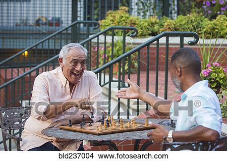Friends playing chess in garden View Large Photo Image Picture - Friends playing chess in garden. Fotosearch