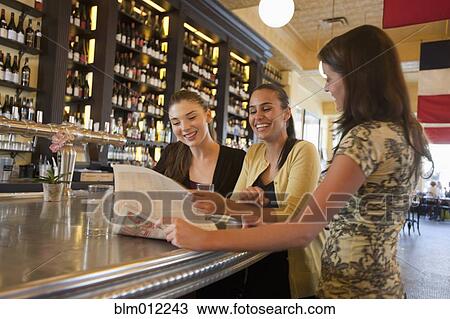 Friends relaxing in restaurant bar together View Large Photo Image Stock Image - Friends relaxing in restaurant bar together. Fotosearch