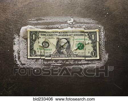 Stock Photograph - Frozen broken dollar bill. Fotosearch