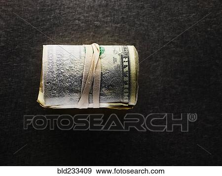 Stock Photo - Frozen roll of dollar bills. Fotosearch