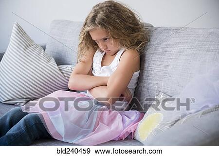 Frustrated girl wearing tutu pouting on sofa View Large Photo Image Stock Photo - Frustrated girl wearing tutu pouting on sofa. Fotosearch