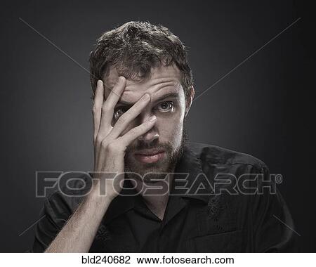 Frustrated man with hand on face View Large Photo Image Stock Image - Frustrated man with hand on face. Fotosearch