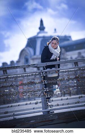 Girl looking over bridge railing View Large Photo Image Stock Photography - Girl looking over bridge railing. Fotosearch