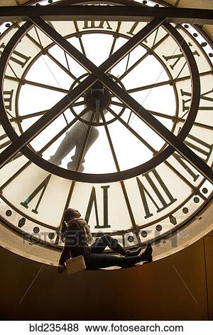 Girl sitting in clock window View Large Photo Image Stock Photo - Girl sitting in clock window. Fotosearch