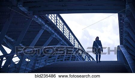 Stock Photograph - Girl walking on staircase. Fotosearch