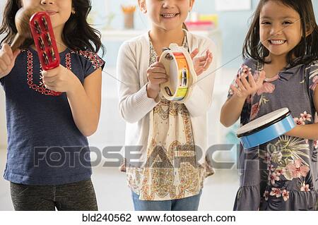 Girls playing music in school View Large Photo Image Stock Image - Girls playing music in school. Fotosearch