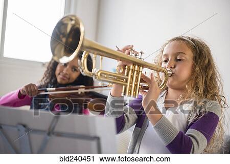Girls practicing playing violin and trumpet View Large Photo Image Stock Image - Girls practicing playing violin and trumpet. Fotosearch