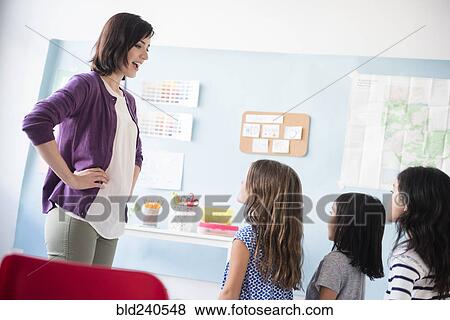 Girls standing in a row for teacher in classroom View Large Photo Image Stock Photo - Girls standing in a row for teacher in classroom. Fotosearch