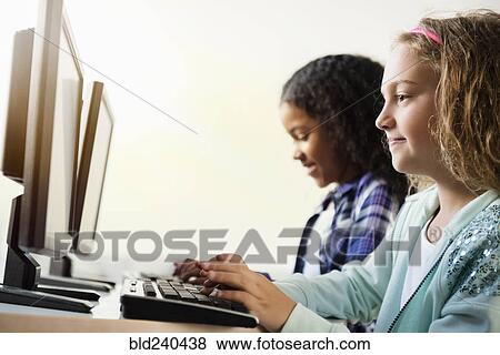 Girls using computers View Large Photo Image Stock Photo - Girls using computers. Fotosearch