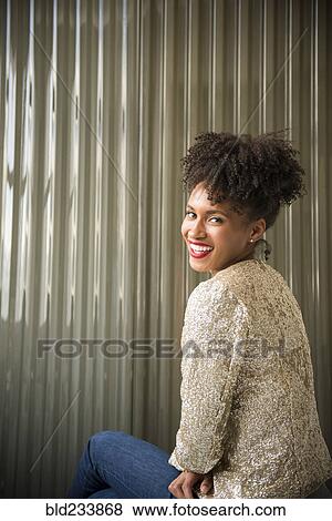 Stock Photo - Glamorous Black woman looking over shoulder. Fotosearch