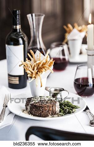 Gourmet pepper steak with french fries and red wine View Large Photo Image Stock Photography - Gourmet pepper steak with french fries and red wine. Fotosearch