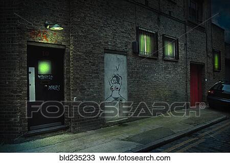 Graffiti on alley doors in city at night View Large Photo Image Stock Image - Graffiti on alley doors in city at night. Fotosearch
