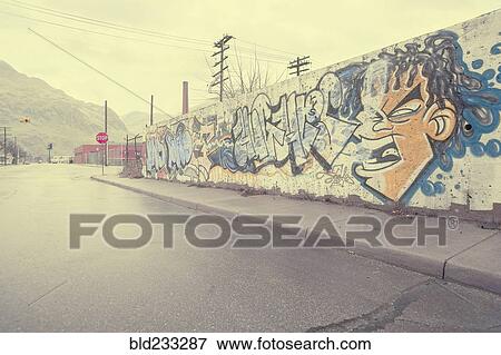 Stock Photo - "Graffiti wall near wet street, Detroit, Michigan, United States". Fotosearch