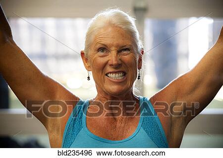 Grimacing older woman working out in gymnasium View Large Photo Image Stock Photograph - Grimacing older woman working out in gymnasium. Fotosearch