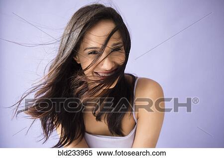 Stock Photography - Hair of Mixed Race woman blowing in wind. Fotosearch