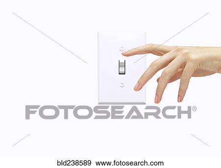 Hand of woman pressing light switch View Large Photo Image Stock Photo - Hand of woman pressing light switch. Fotosearch