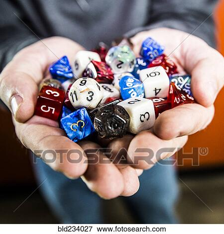 Stock Photo - Hands holding variety of dice. Fotosearch