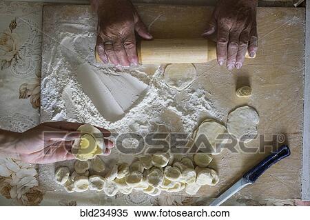 Stock Photography - Hands of Caucasian woman rolling pastry dough. Fotosearch