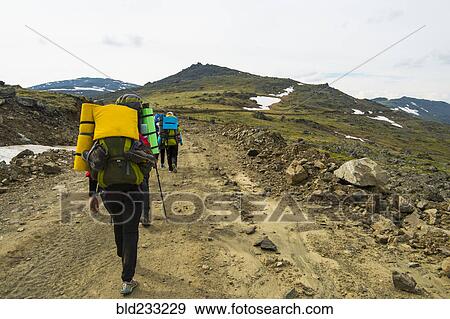 Hikers walking on mountain path in winter View Large Photo Image Stock Photo - Hikers walking on mountain path in winter. Fotosearch