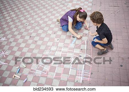 Hispanic boy and girl drawing with chalk on sidewalk View Large Photo Image Stock Image - Hispanic boy and girl drawing with chalk on sidewalk. Fotosearch