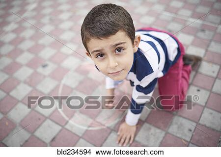 Hispanic boy drawing with chalk on sidewalk View Large Photo Image Picture - Hispanic boy drawing with chalk on sidewalk. Fotosearch