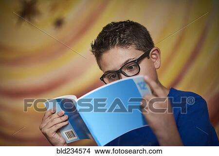 Hispanic boy reading blue book View Large Photo Image Picture - Hispanic boy reading blue book. Fotosearch